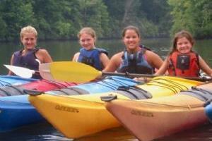Girls kayaking in a lake.