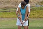 Instructor Teaching Golf Swing to Young Woman